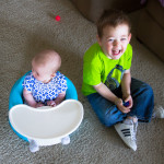 Maisie Sitting in Bumbo with Eli Before School