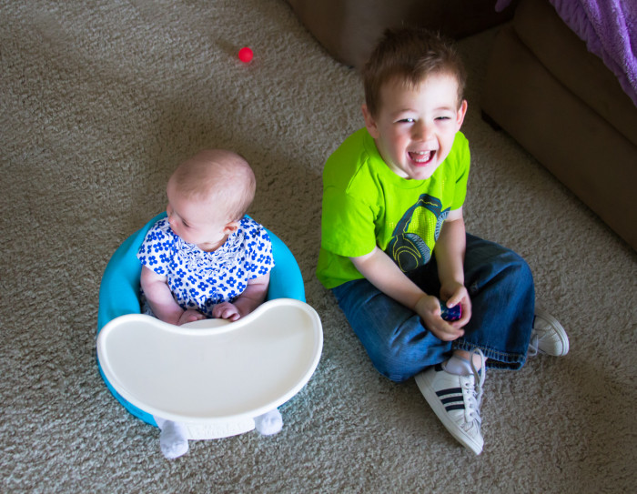 Maisie Sitting in Bumbo with Eli Before School